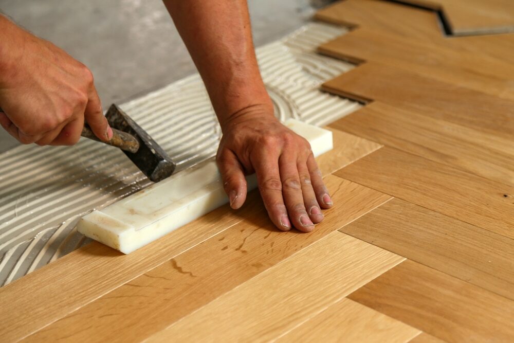 Herringbone oak parquet being laid by hand
